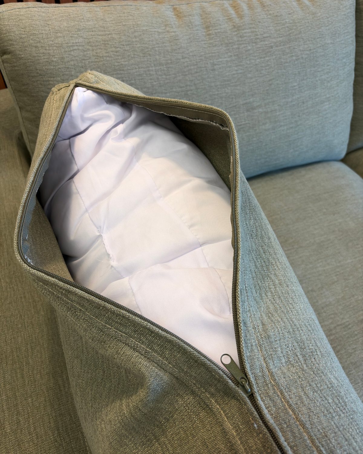 Unzipped Aspen Cloud Petite cushion cover in Sage Green linen showing the removable insert