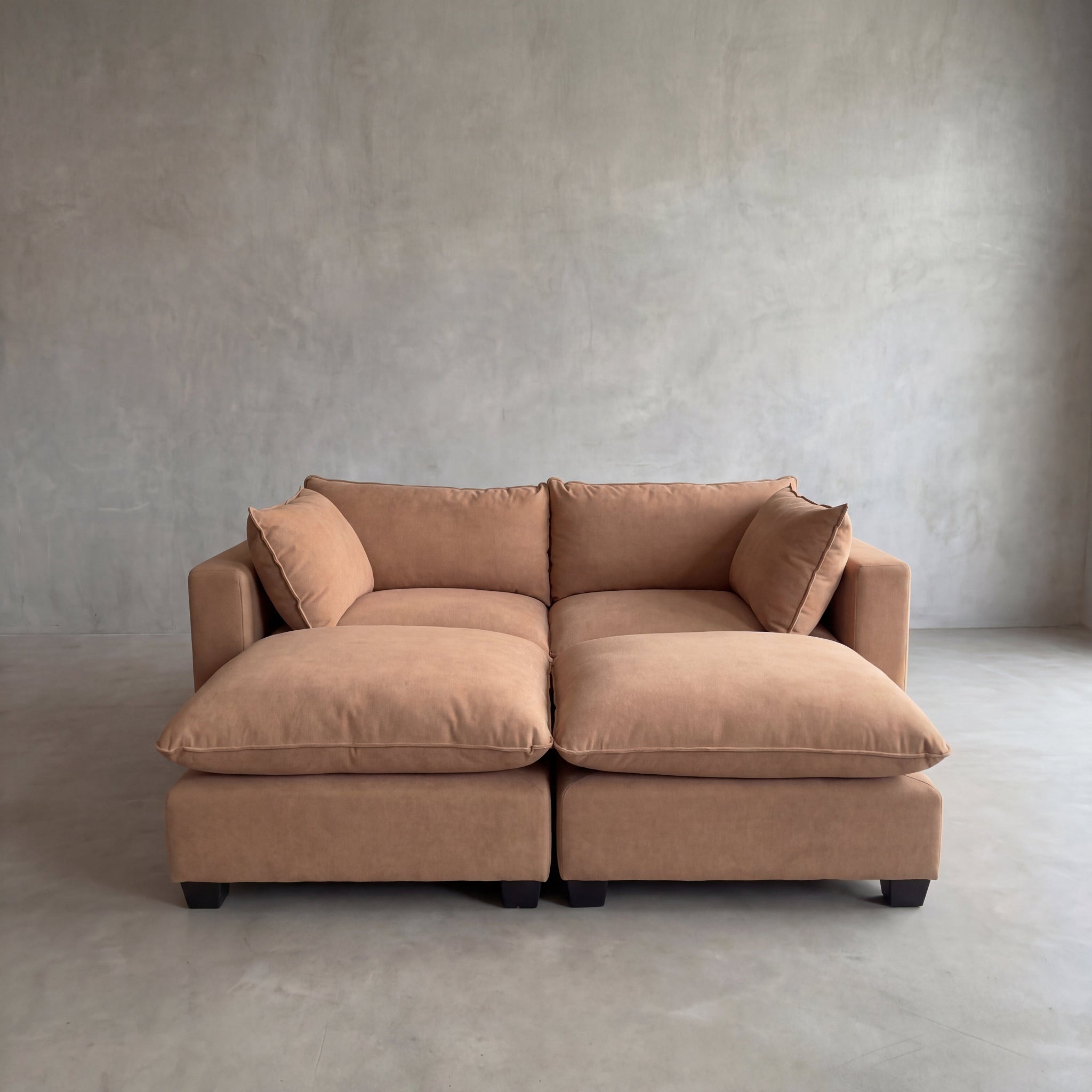Brown sectional sofa against a plain wall.