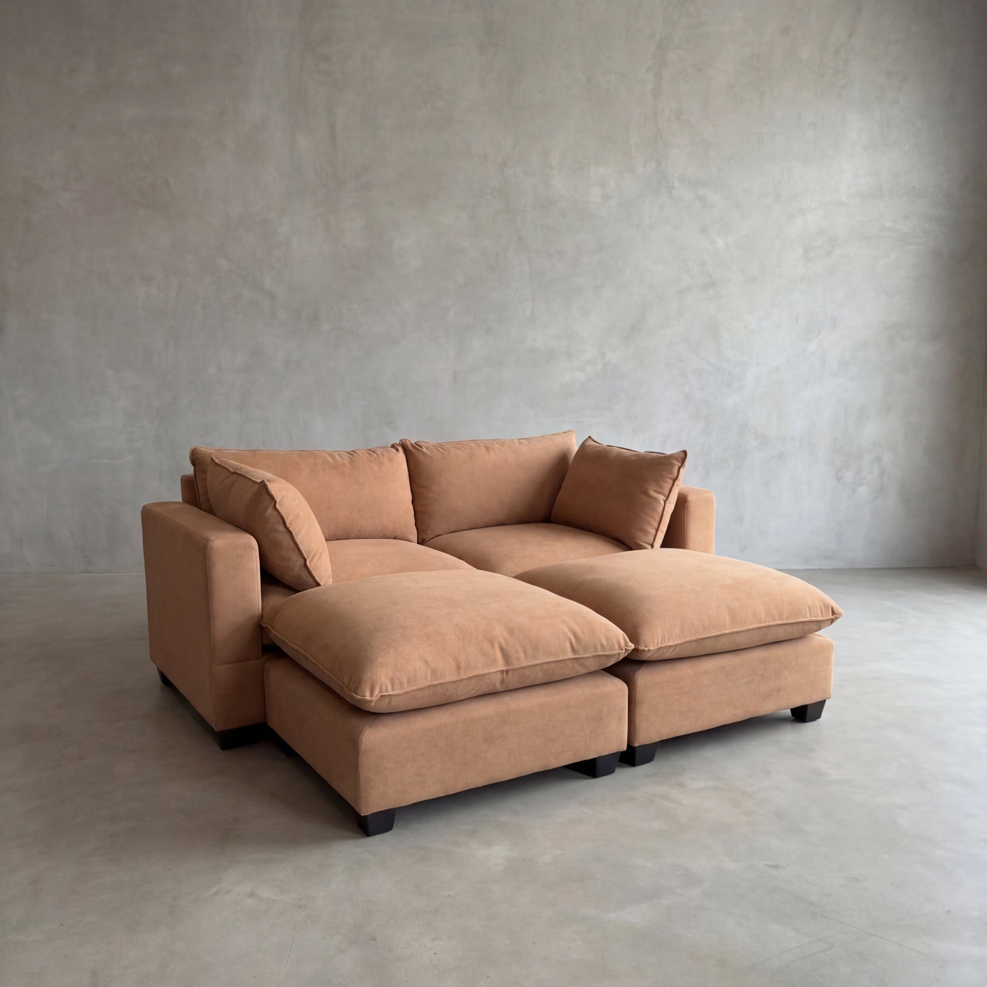 Brown sectional sofa in a minimalistic room with gray walls and floor.