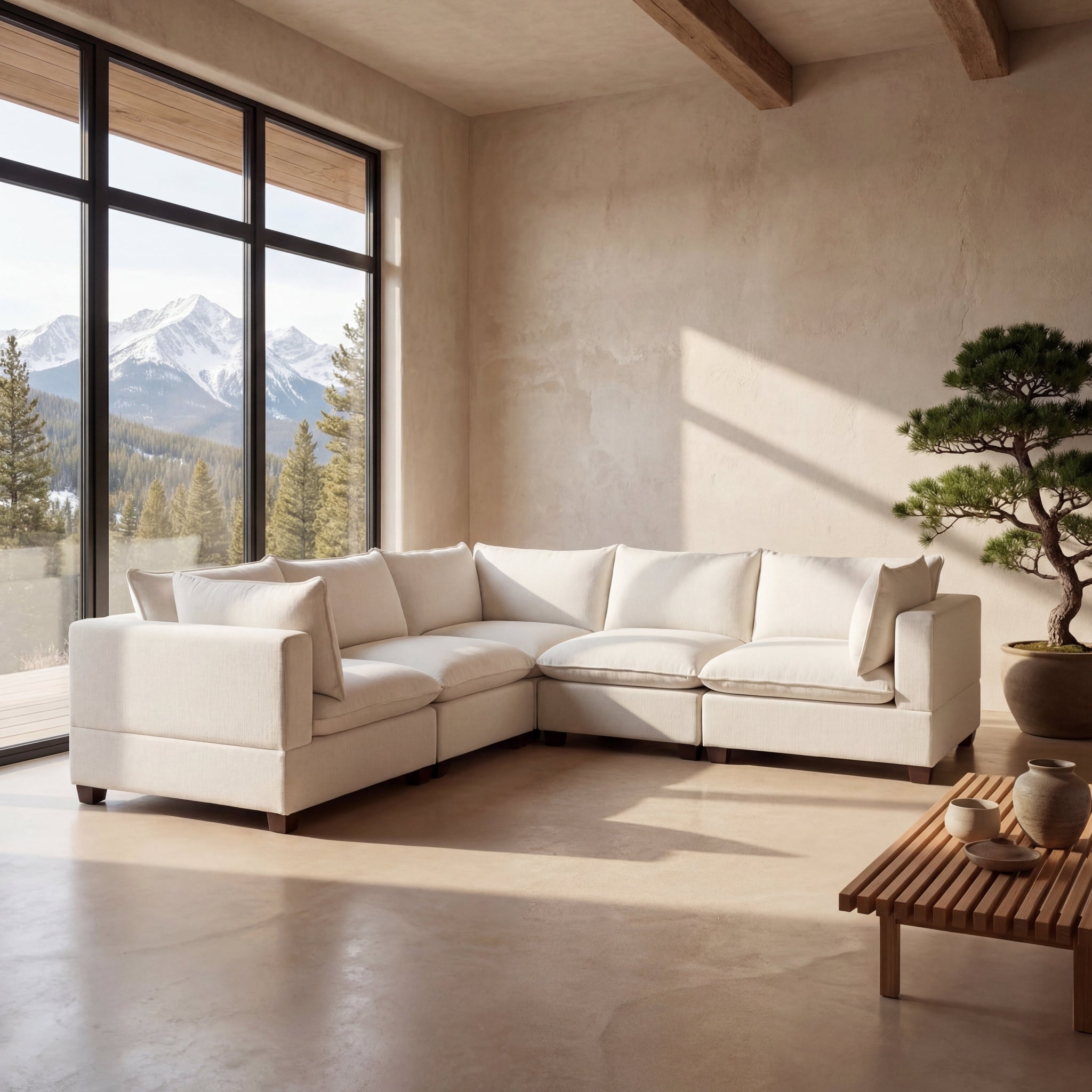 Cream sectional sofa in a living room with a mountain view.