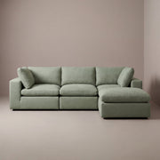 modular cloud sectional sofa with ottoman in a sage green linen fabric
