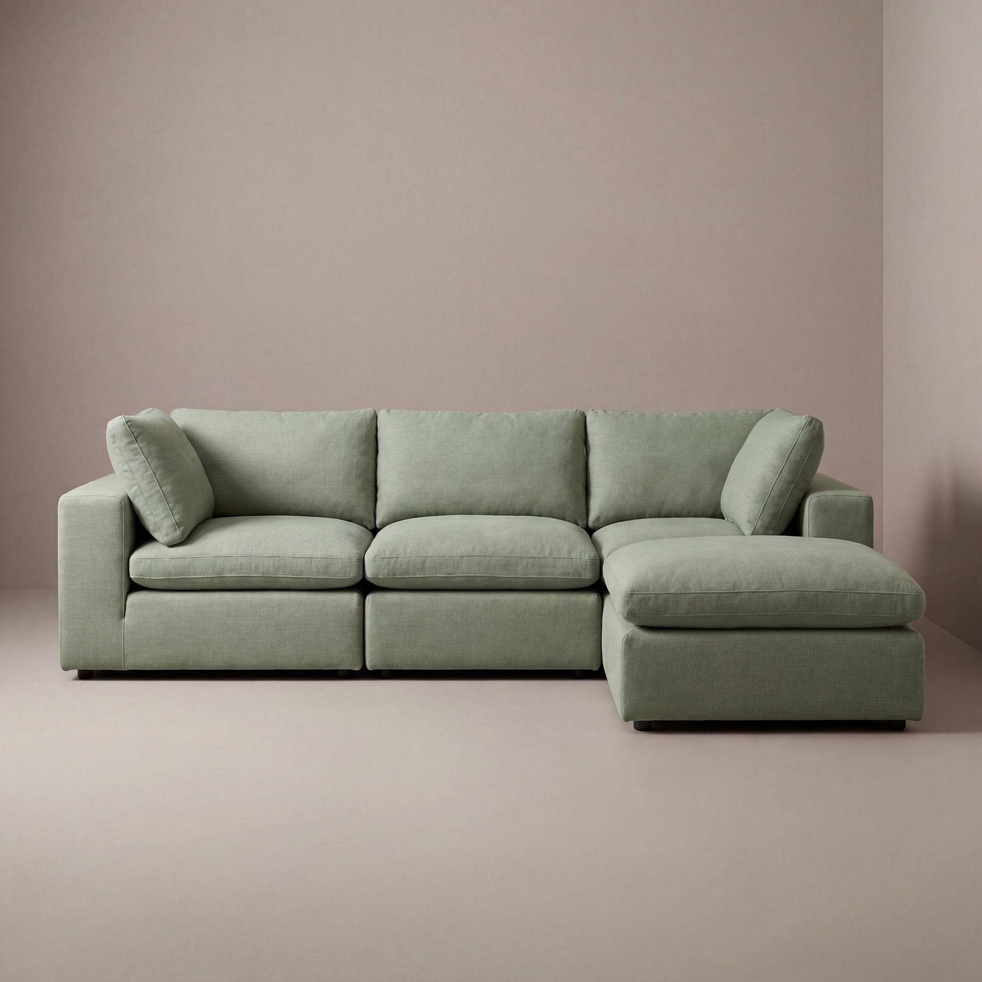 modular cloud sectional sofa with ottoman in a sage green linen fabric

