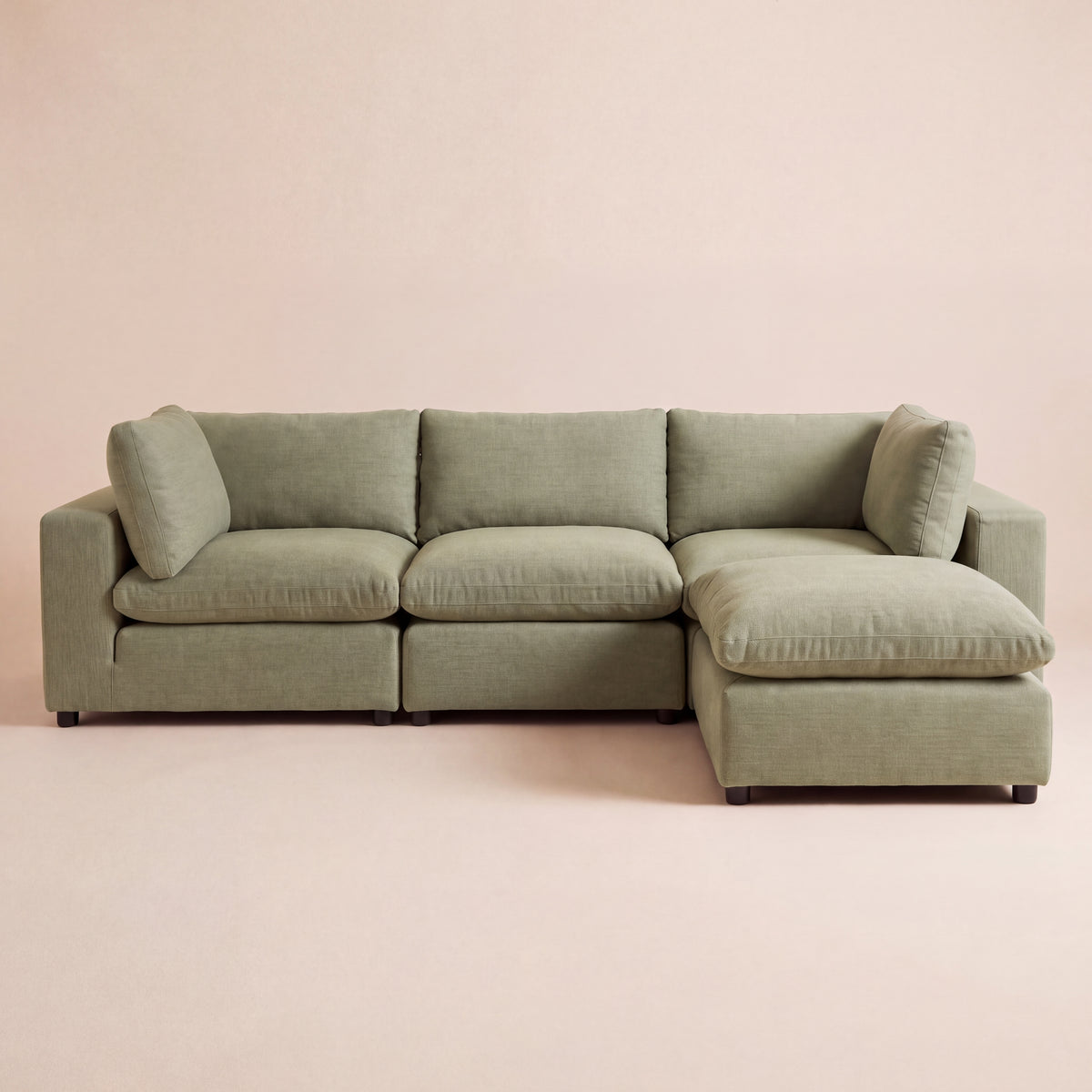 A sage green sectional sofa with a reversible chaise lounge with a modular design