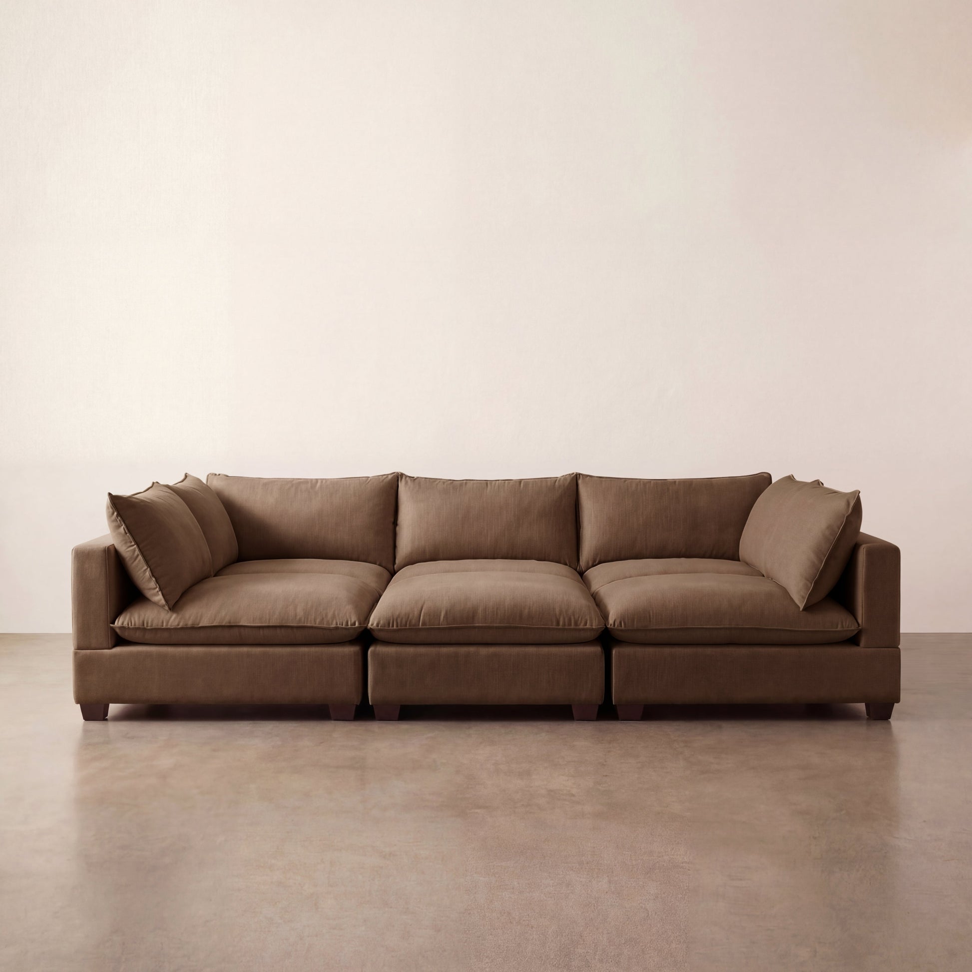 Chocolate Brown modular sectional sofa on a beige floor with a plain wall background