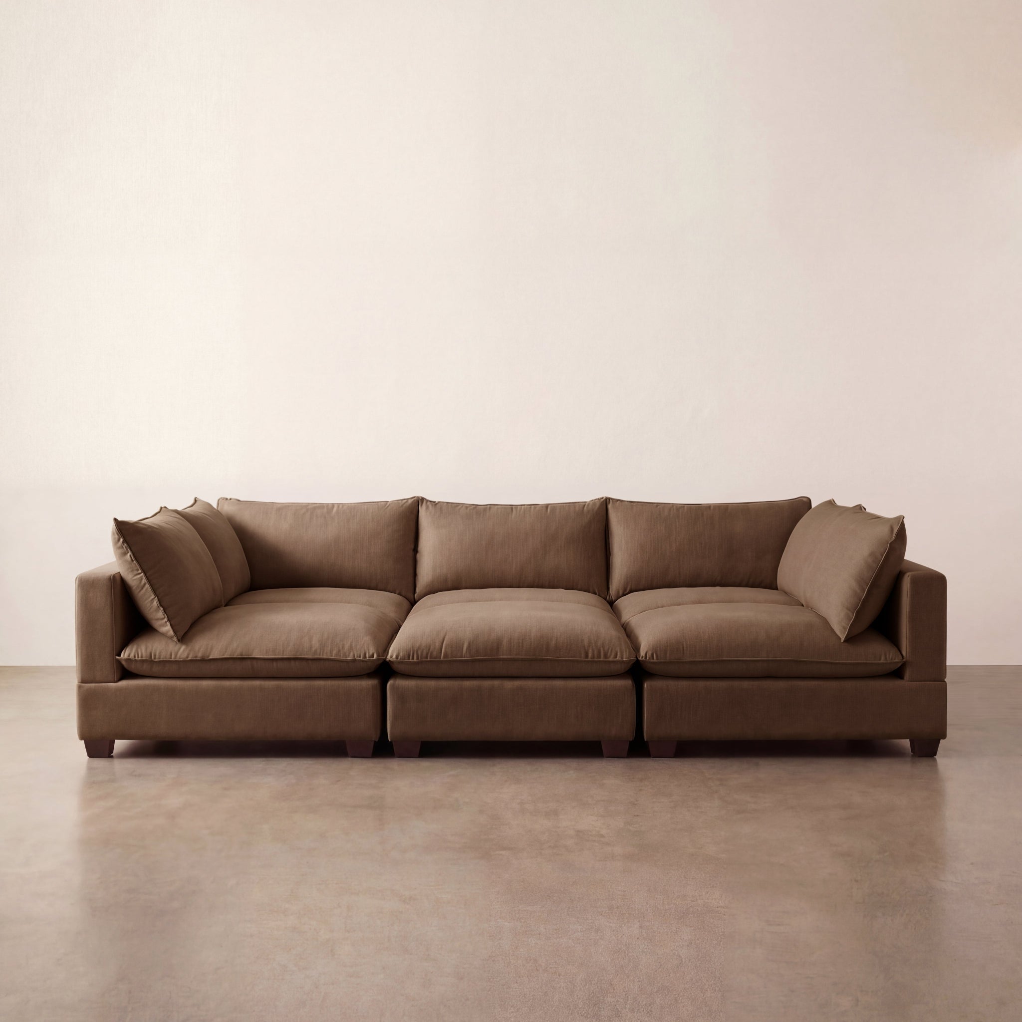 Chocolate Brown modular sectional sofa on a beige floor with a plain wall background